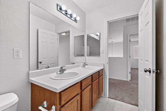 8905 Balsam Glade Rd NW, Albuquerque, NM 87114 - bathroom featuring double vanity and tile patterned floors