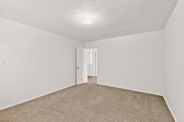 8905 Balsam Glade Rd NW, Albuquerque, NM 87114 - carpeted spare room featuring a textured ceiling and baseboards