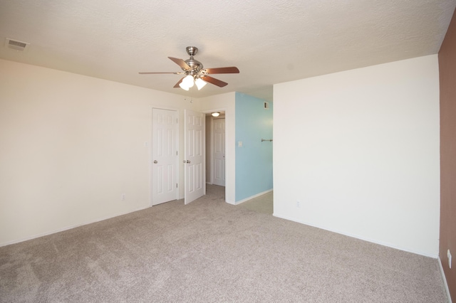 12910 Alice Ave NE, Albuquerque, NM 87112 - unfurnished room featuring light colored carpet, a ceiling fan, and a textured ceiling