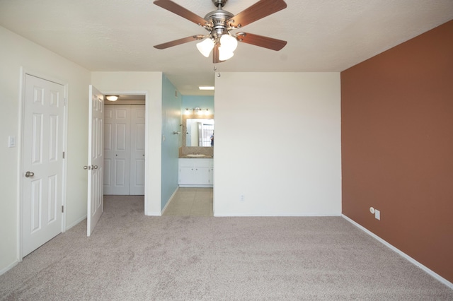 12910 Alice Ave NE, Albuquerque, NM 87112 - unfurnished bedroom featuring carpet, ensuite bath, and ceiling fan