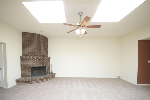 12910 Alice Ave NE, Albuquerque, NM 87112 - unfurnished living room with a skylight, carpet flooring, ceiling fan, and a fireplace