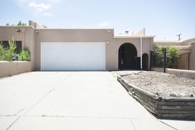 12910 Alice Ave NE, Albuquerque, NM 87112 - adobe home featuring a garage, stucco siding, and concrete driveway