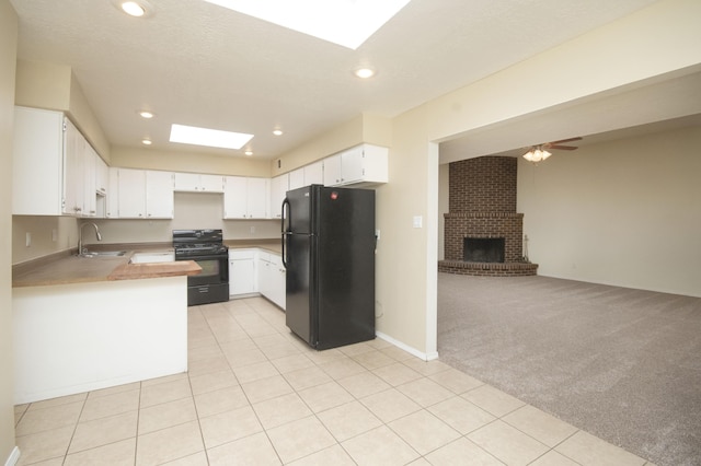 12910 Alice Ave NE, Albuquerque, NM 87112 - kitchen featuring black appliances, open floor plan, a skylight, light carpet, and recessed lighting