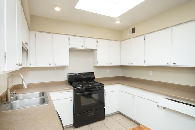 12910 Alice Ave NE, Albuquerque, NM 87112 - kitchen featuring black gas range oven, white cabinetry, recessed lighting, light tile patterned floors, and light countertops