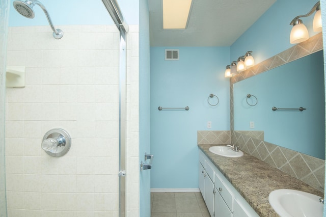12910 Alice Ave NE, Albuquerque, NM 87112 - bathroom featuring a shower stall, tile patterned floors, double vanity, and tasteful backsplash