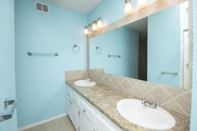 12910 Alice Ave NE, Albuquerque, NM 87112 - bathroom with double vanity, tile patterned floors, and backsplash