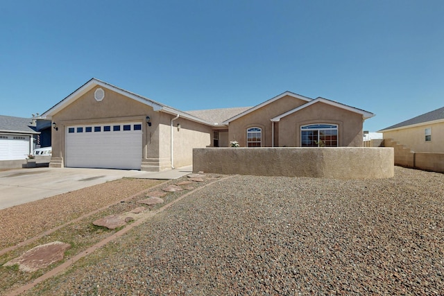 2062 Valley View Dr SW, Los Lunas, NM 87031 - ranch-style home featuring stucco siding, an attached garage, and concrete driveway
