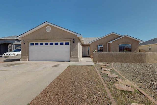 2062 Valley View Dr SW, Los Lunas, NM 87031 - single story home featuring stucco siding, an attached garage, and concrete driveway