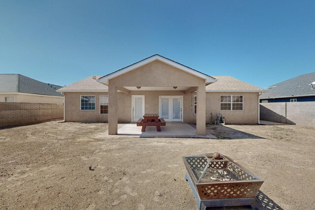 2062 Valley View Dr SW, Los Lunas, NM 87031 - back of property with stucco siding, an outdoor fire pit, a fenced backyard, and a patio