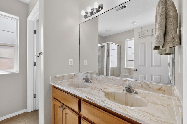 2062 Valley View Dr SW, Los Lunas, NM 87031 - full bath featuring double vanity, a stall shower, and tile patterned floors