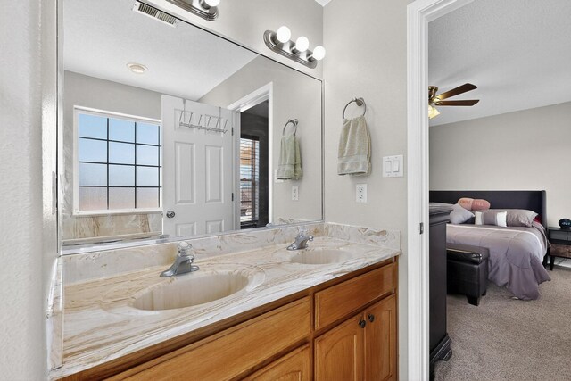 2062 Valley View Dr SW, Los Lunas, NM 87031 - bathroom featuring double vanity, ensuite bathroom, and ceiling fan
