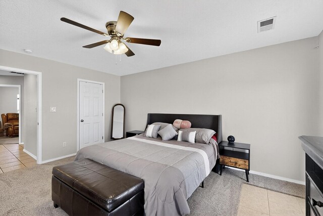 2062 Valley View Dr SW, Los Lunas, NM 87031 - bedroom with light colored carpet, light tile patterned floors, and ceiling fan