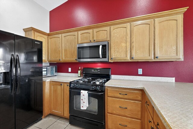 2062 Valley View Dr SW, Los Lunas, NM 87031 - kitchen featuring black appliances, light countertops, light tile patterned flooring, and vaulted ceiling
