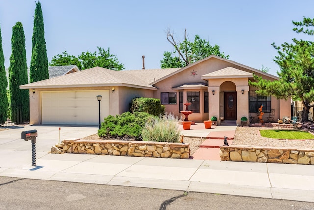 5131 Gaviota NW, Albuquerque, NM 87120 - view of front facade with stucco siding, an attached garage, concrete driveway, and a shingled roof