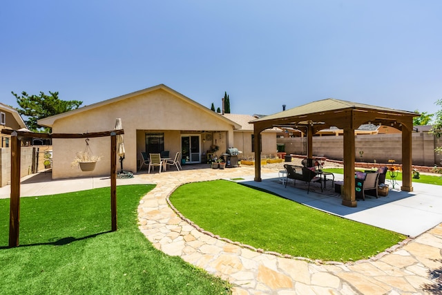 5131 Gaviota NW, Albuquerque, NM 87120 - back of property featuring stucco siding, a patio area, a gazebo, and an outdoor hangout area