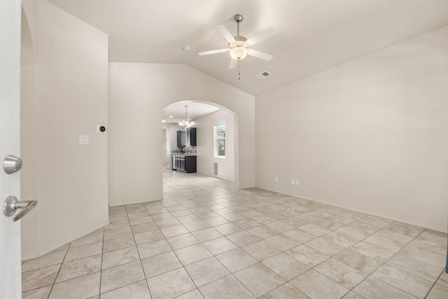 5723 Strand Loop SE, Albuquerque, NM 87106 - spare room featuring arched walkways, vaulted ceiling, a ceiling fan, a chandelier, and light tile patterned floors