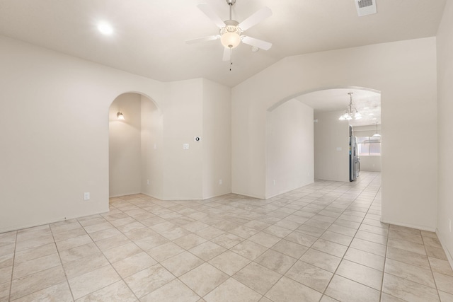 5723 Strand Loop SE, Albuquerque, NM 87106 - spare room featuring arched walkways, a ceiling fan, light tile patterned flooring, a chandelier, and vaulted ceiling