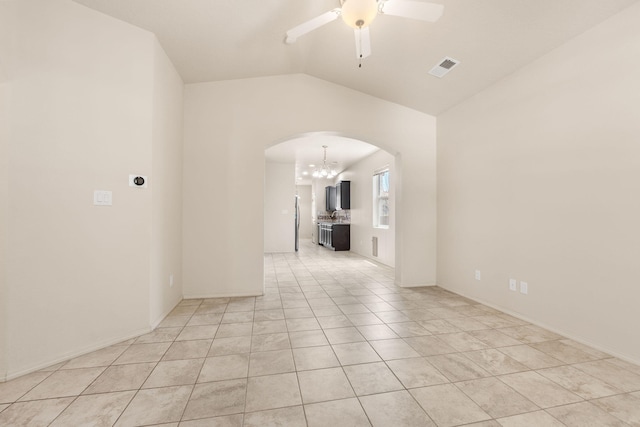 5723 Strand Loop SE, Albuquerque, NM 87106 - empty room featuring arched walkways, a chandelier, ceiling fan, vaulted ceiling, and light tile patterned floors