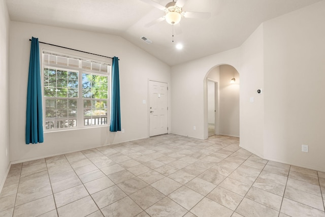 5723 Strand Loop SE, Albuquerque, NM 87106 - empty room with arched walkways, a ceiling fan, lofted ceiling, and light tile patterned flooring