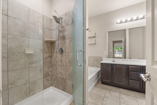 5723 Strand Loop SE, Albuquerque, NM 87106 - bathroom with a shower stall, vanity, a garden tub, and tile patterned flooring