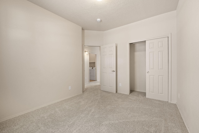 5723 Strand Loop SE, Albuquerque, NM 87106 - unfurnished bedroom featuring light colored carpet, a closet, a textured ceiling, and washing machine and clothes dryer