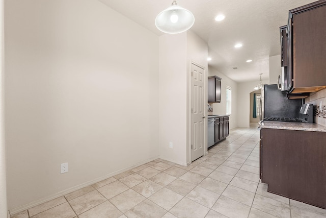 5723 Strand Loop SE, Albuquerque, NM 87106 - kitchen with stove, recessed lighting, dark brown cabinetry, light tile patterned floors, and tasteful backsplash