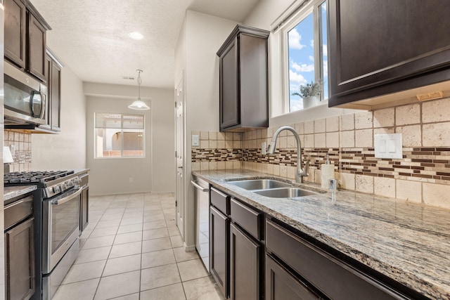 5723 Strand Loop SE, Albuquerque, NM 87106 - kitchen with stainless steel appliances, dark brown cabinets, plenty of natural light, and a textured ceiling