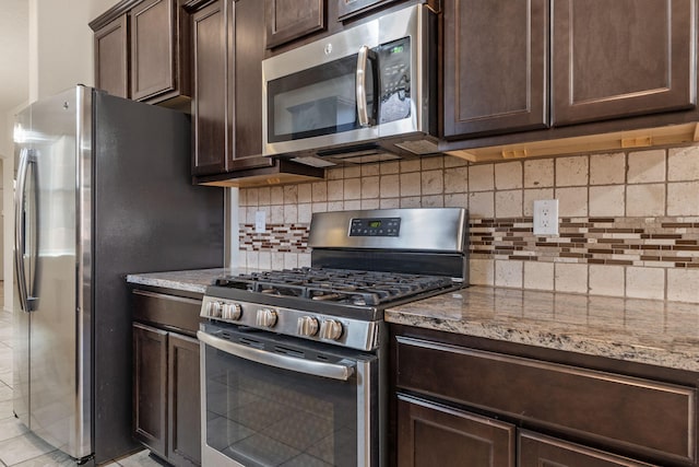 5723 Strand Loop SE, Albuquerque, NM 87106 - kitchen featuring stainless steel appliances, dark brown cabinets, light stone counters, and decorative backsplash