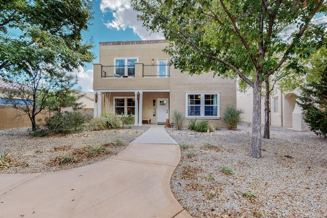 5716 Strand Loop SE, Albuquerque, NM 87106 - view of front facade with a balcony, covered porch, and stucco siding