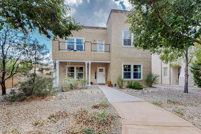 5716 Strand Loop SE, Albuquerque, NM 87106 - view of front of property featuring a balcony, stucco siding, and covered porch