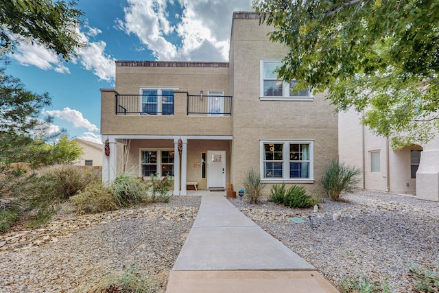 5716 Strand Loop SE, Albuquerque, NM 87106 - view of front of home with a balcony, a porch, and stucco siding