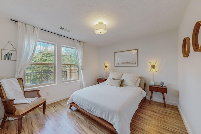 5716 Strand Loop SE, Albuquerque, NM 87106 - bedroom with light wood-style flooring and a textured ceiling