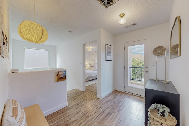 5716 Strand Loop SE, Albuquerque, NM 87106 - entryway with light wood-style flooring and a textured ceiling
