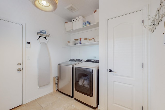 5716 Strand Loop SE, Albuquerque, NM 87106 - washroom featuring washing machine and clothes dryer and light tile patterned floors