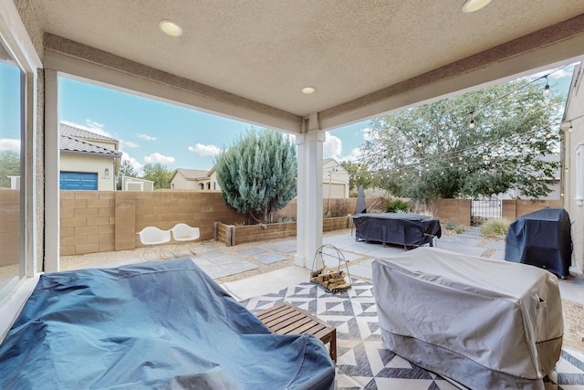 5716 Strand Loop SE, Albuquerque, NM 87106 - fenced backyard featuring a patio area, a grill, and outdoor lounge area