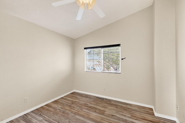 9900 Ladder Ranch Ln SW, Albuquerque, NM 87121 - spare room with wood finished floors, vaulted ceiling, and ceiling fan