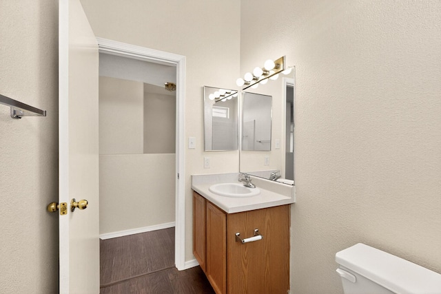 9900 Ladder Ranch Ln SW, Albuquerque, NM 87121 - half bathroom with vanity and wood finished floors