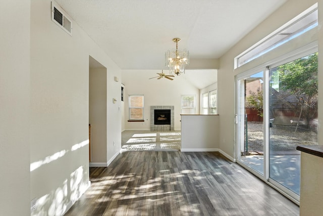7816 Bursera Dr NW, Albuquerque, NM 87120 - unfurnished living room featuring a chandelier, wood finished floors, a tiled fireplace, and lofted ceiling