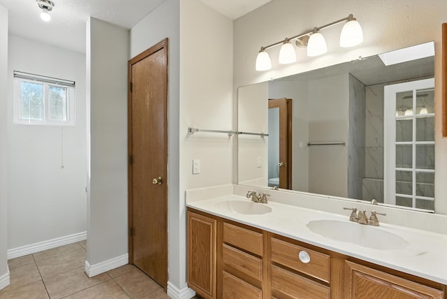 7816 Bursera Dr NW, Albuquerque, NM 87120 - bathroom with double vanity, tile patterned flooring, and a shower