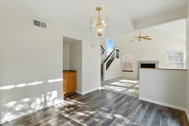 7816 Bursera Dr NW, Albuquerque, NM 87120 - unfurnished living room featuring dark wood-style flooring, vaulted ceiling, stairs, ceiling fan, and a fireplace