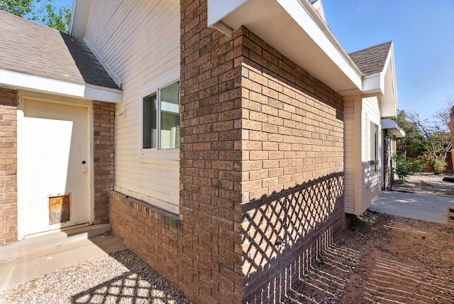 7816 Bursera Dr NW, Albuquerque, NM 87120 - view of side of property featuring brick siding and a shingled roof