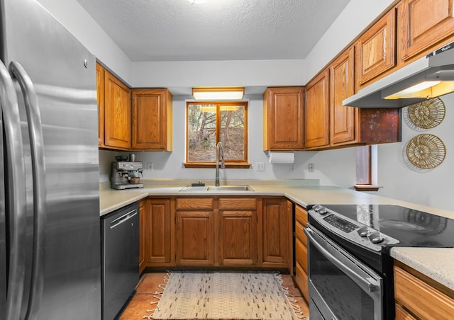 113 Sandia Crest Rd, Sandia Park, NM 87047 - kitchen with stainless steel appliances, under cabinet range hood, brown cabinetry, light countertops, and a textured ceiling