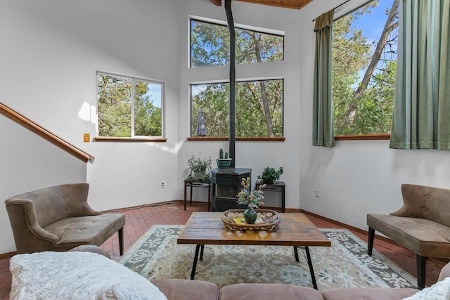 113 Sandia Crest Rd, Sandia Park, NM 87047 - living area featuring healthy amount of natural light, a towering ceiling, and a wood stove