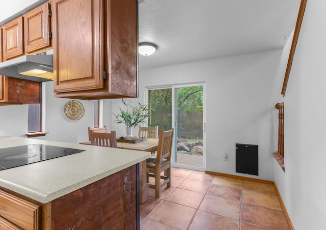 113 Sandia Crest Rd, Sandia Park, NM 87047 - kitchen with range hood, light countertops, and light tile patterned flooring