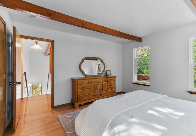 113 Sandia Crest Rd, Sandia Park, NM 87047 - bedroom featuring beam ceiling and light wood-style flooring