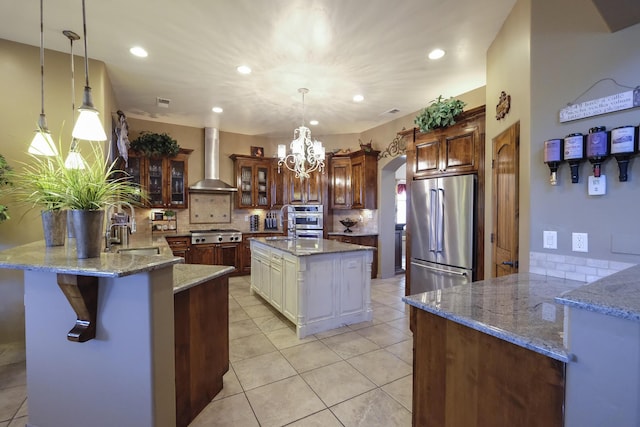 9604 Big Sage Dr NW, Albuquerque, NM 87114 - kitchen featuring stainless steel appliances, wall chimney range hood, arched walkways, decorative backsplash, and recessed lighting