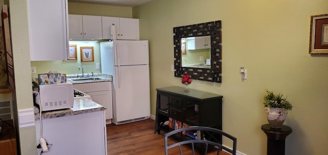 2800 Vail Ave SE Unit M 163, Albuquerque, NM 87106 - kitchen with white appliances, white cabinets, dark wood-type flooring, and light countertops