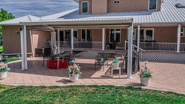 40 La Bajada Rd, Los Lunas, NM 87031 - back of house featuring stucco siding, a metal roof, and a patio area