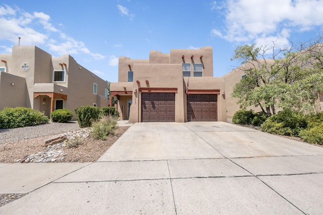 10027 Vista Cantera Ln NW, Albuquerque, NM 87114 - southwest-style home featuring an attached garage, stucco siding, and concrete driveway