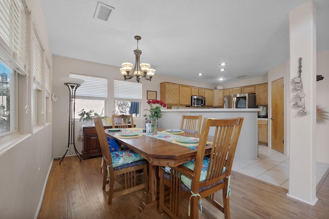 10027 Vista Cantera Ln NW, Albuquerque, NM 87114 - dining space with a chandelier, light wood-style flooring, and recessed lighting